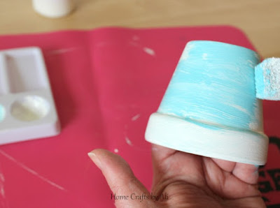 Use sponge to add colorful paint to pots