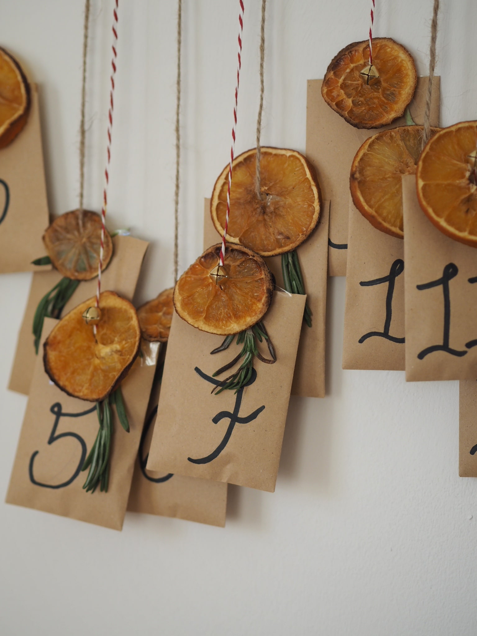 How to make a simple scandi-style DIY Christmas advent calendar using envelopes and dried orange slices. Budget Christmas decor craft inspiration.