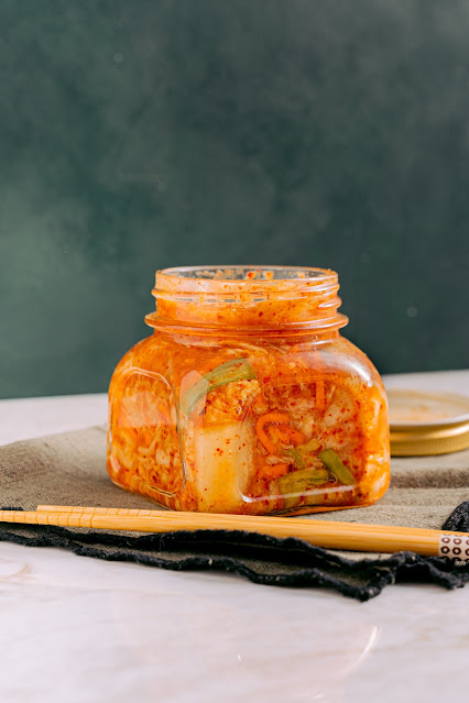 A bowl of traditional Korean Kimchi, a fermented vegetable dish rich in probiotics and flavors.