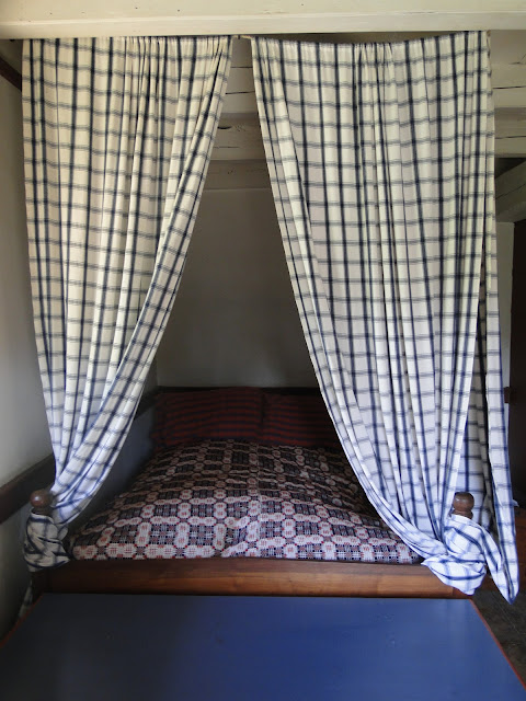 blue check curtains on four poster bed