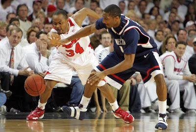 Jerry Smith #34 of the Louisville Cardinals and Marcus Johnson #1 of the Connecticut 