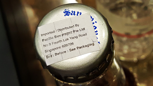 importation sticker on the cap of a San Miguel Light bottle in Singapore