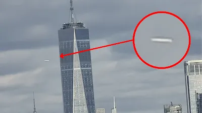 A close up look at the white cigar shape UFO over New York.