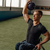 A man lifting a kettlebell while sitting on his wheelchair