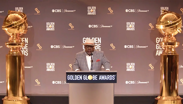 A screenshot of Cedric “The Entertainer” announcing Golden Globes nominations, with life-size statuettes on either side of him.