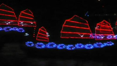 Image of a neon-lit 'Chinese Junk' on the water for the opening of the 2009 East Asian Games in Hong Kong