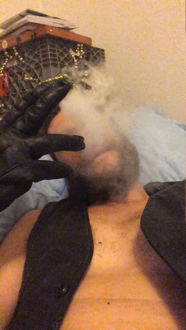 Bearded Oregonleatherboy blowing thick smoke wearing smooth black leather vest and gloves hypnosmoke created by Oregonleatherboy
