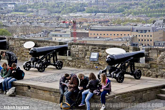 Edinburgh Castle is a fortress which dominates the skyline of the city of Edinburgh, Scotland !!! Human habitation of the site is dated back as far as the 9th century BC, although the nature of early settlement is not clear.  As one of the most important fortresses in the Kingdom of Scotland, Edinburgh Castle was involved in many historical conflicts, from the Wars of Scottish Independence ...Although Edinburgh Castle is formally owned by the Ministry of Defence of Scotland but most of the castle is now in the care of Historic Scotland and it is Scotland's most-visited paid tourist attraction.Edinburgh - Castle and train station !!The garrison left in the 1920s, but there is still a military presence at the castle... Military is largely ceremonial and administrative and including a number of regimental museums. It is the backdrop to the annual Edinburgh Military Tattoo and has become a recognizable symbol of Edinburgh and of Scotland.Another view of Edinburgh City from Royal Castle touching skylines..Inside Edinbugh Castle with some barracks on the left !!!!Inside Edinburgh CastleChapel inside Edinbugh Castle...People walking inside Inside Edinburgh CastleEdinburgh Castle - Mons MegMons Meg is a medieval super-gun now located at Edinburgh Castle, Scotland. There are varied views about it's origins, but it appears from the accounts of Philip the Good, Duke of Burgundy that it was made to his order around 1449 and sent as a gift 8 years later to King James II of Scotland, with other artillery supplies... This is picked from Wikipedia !Edinburgh Castle - Walking on the streets..View of Edinburgh city from Castle...St. Margaret's Chapel inside Edinburgh Castle - One on the oldest sections of this Castle !!!St. Margaret's Chapel in inside Edinburgh Castle of Scotland and it's the oldest surviving building in Edinburgh, Scotland. An example of Romanesque architecture, it is a Category A listed buildingLegend had it that St. Margaret worshiped in this small chapel, but recent research indicates that it was built at the beginning of the 12th century by her fourth son who became King David in 1124. The building has been restored and the interior presents much the same appearance as it did when first in use.Some colorful paintings form St. Margaret's Chapel inside Edinburgh Castle - One on the oldest sections of this CastleHalf Moon Battery and David's Tower...The Half Moon Battery, which remains a prominent feature on the east side of the castle, was built as part of the reconstruction works..Edinburgh Castle - Canons on the outer walls of this CastlView of Edinburgh City from Castle ...Oldest building in the castle, and in Edinburgh, is the small St. Margaret's Chapel ...Oldest building in the castle, and in Edinburgh- small St. Margaret's ChapelThe Royal Palace in Crown SquareThere are clear Directions about the places inside Edinburgh Castle - Royal Apartments, Great Hall etcThe Royal Palace comprises the former royal apartments which were the residence of the later Stewart monarchs. It was begun in the mid 15th century and it originally communicated with David's Tower.The Royal Palace in Crown Square - Inside Edinburgh Castle ... A closer look !!!Flag inside Edinburgh Castle ..There are lots of cannons on outer walls of Edinburgh Castle from where whole city is clearly visible ... Since it's situated on height, these areas give wonderful view of Edinburgh City !!The Scottish National War Memorial inside Edinburgh Castle - Scotland by Ashish ...The Scottish National War Memorial is located inside Edinburgh Castle and commemorates Scottish soldiers... It's for those serving with Scottish regiments, who died in the two world wars and in more recent conflicts. The monument was formally opened in 1927. It is housed in a redeveloped barrack block in Crown Square, at the heart of the castle, and incorporates numerous monuments.Inside Edinburgh Castle - People walking in Relaxed mode ...Canon areas inside Edinburgh Castle - Scotland Travel Photo Journey by Ashish ..A View of Edinburgh City from Castle of Edinburgh ..Beautiful Edinburgh City with nice view to the water-body in background...Architecture of Edinburgh City and Castle is really lovable... n would want to click photographs of such places again in future..Tourists looking at the map to ensure that they don't miss anything inside the castle. Also it helps to know which are main attractions which must be visited and which others can be compromised as per available time...Beautiful buildings around Royal Mile in Edinburgh city !!!The Royal Mile is a succession of streets which form the main thoroughfare of the Old Town of the city of Edinburgh in Scotland.Part of the Royal mile inside Edinburgh city of Scotland ...The Royal Mile is approximately one Scots mile long and runs between two foci of history in Scotland, from Edinburgh Castle at the top of the Castle Rock down to Holyrood Abbey. The streets which make up the Royal Mile are (west to east) Castle Esplanade, Castlehill, Lawnmarket, High Street, Canongate and Abbey Strand. The Royal Mile is Edinburgh Old Town's busiest tourist street...Edinburgh Castle is huge as you might have got an idea from all these photographs.. See the size of people roaming around and building around... This photograph must be helpful in setting right perspective about buildings inside Castle !!!Camera Obscura at Edinburgh City of Scotland ...The camera obscura is an optical device that projects an image of its surroundings on a screen. It is used in drawing and for entertainment, and was one of the inventions that led to photography. The device consists of a box or room with a hole in one side. Light from an external scene passes through the hole and strikes a surface inside where it is reproduced, upside-down, but with color and perspective preserved. The image can be projected onto paper, and can then be traced to produce a highly accurate representation.