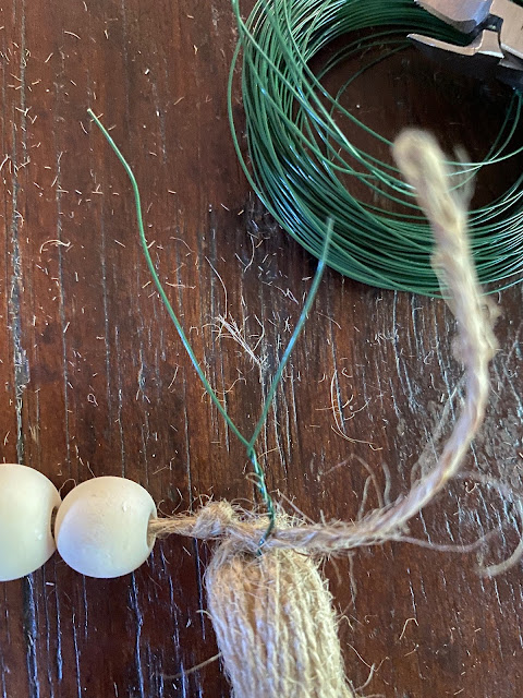 two wooden beads floral wire twine tassel