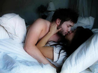couple kissing on bed