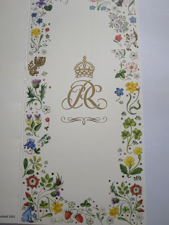 Front of the card we received from the King and Queen, showing the royal coat of arms, with floral decoration around the edges of the card