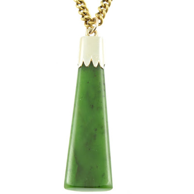An Art Deco style necklace with an asymmetrical large Jade stone as the pendant