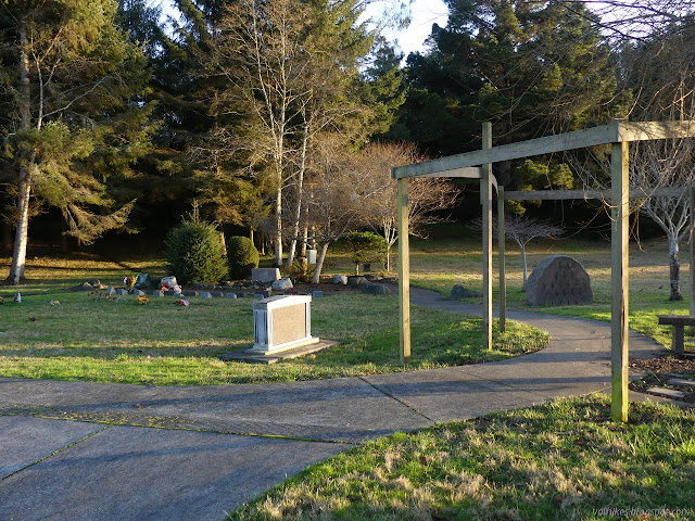 memorials placed tightly in a small stand of trees