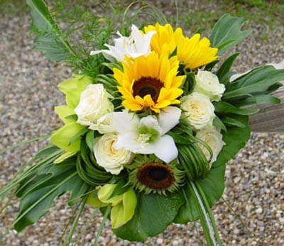 Beautiful bridal bouquet made of sunflowers white roses and white lilies