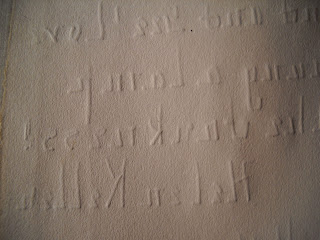 The back of the note, through which the impressions of the letters are strongly pressed.