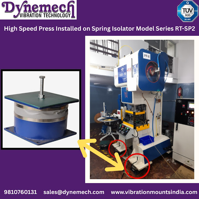 High-speed press machine installed on Dynemech RT-SP2 Spring Isolators, showcasing a factory setup with close-up view of the spring isolator unit and machine base.