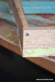 screwing the corners together on a tray made from salvaged wood