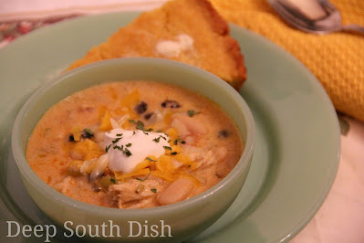 A creamy version of chicken tortilla soup, made with cooked chicken and fajita seasonings. Served with a garnish of crispy tortilla strips, shredded cheese, sour cream and served here with a side of sour cream cornbread.