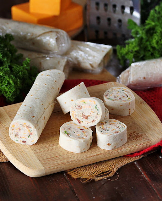 Cutting Bacon-Cheddar Ranch Roll-Ups into Pieces Image