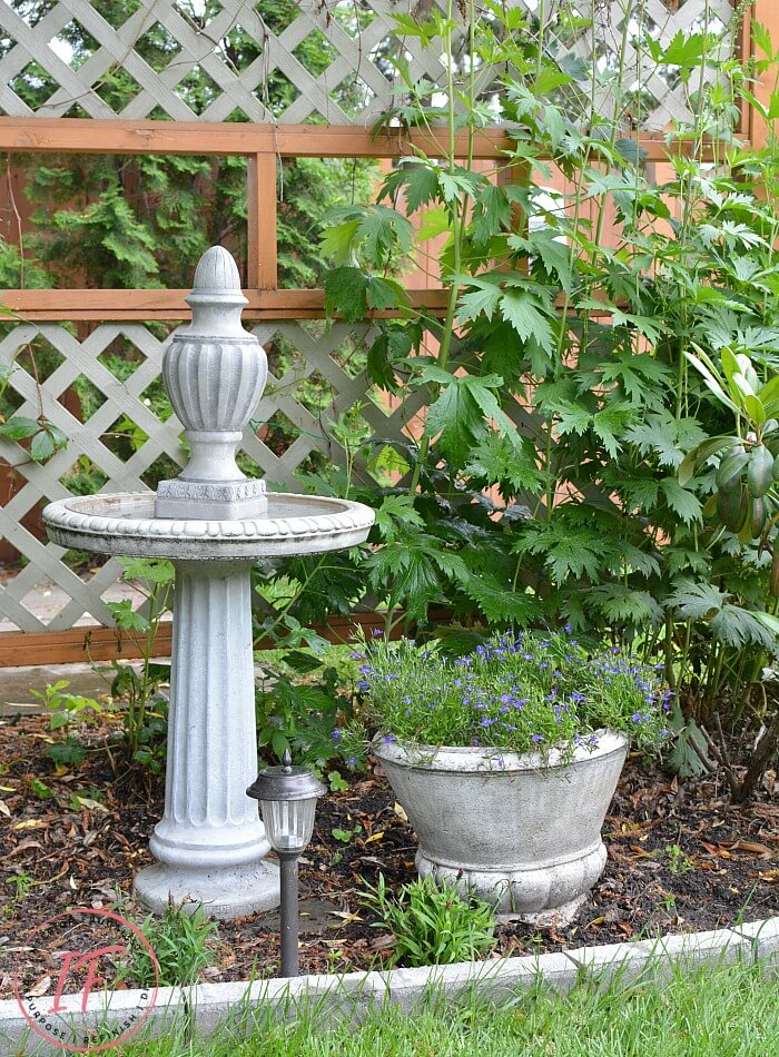 A DIY Faux Concrete Bird Bath Topper and how to make the resin finial look just like the real concrete bird bath it's mounted on with layers of paint.