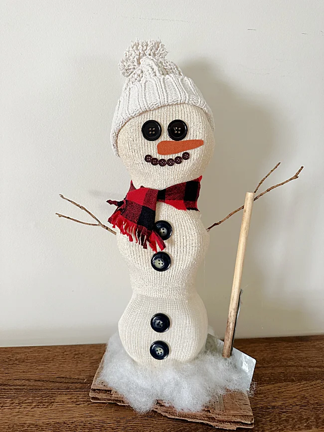 standing snowman with shovel