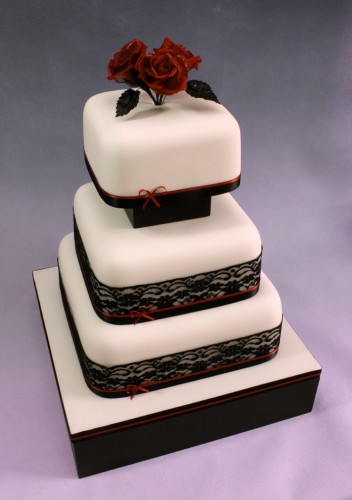 Striking red roses and black lace on white squares on a black base with 