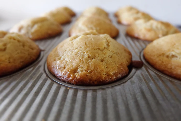 freshly baked upside down pecan sticky muffins in pan