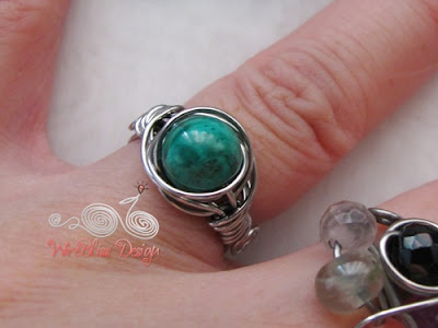 Twice Around the World (TAW) wire wrapped ring with Malachite around finger