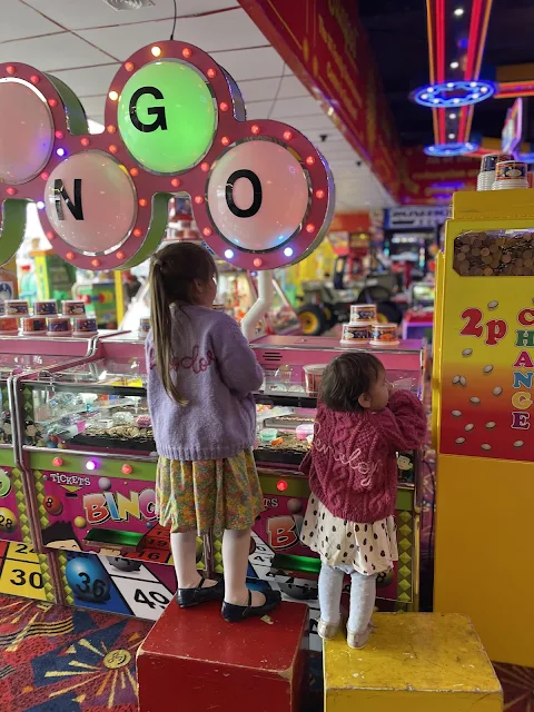 children playing with 2 penny slots in an arcade below Kingpin bowling in Southend