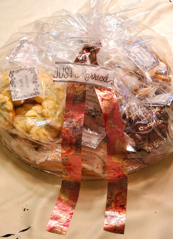 this is a wedding cookie tray full of assorted Italian cookies on a round plastic cookie tray with cookie plastic bag and just married label