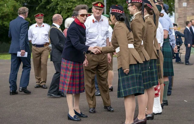 Princess Anne wore a red tartan skirt and navy black jacket. Gold earrings