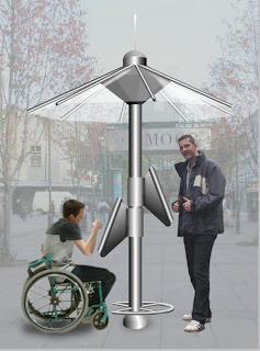 Moving on from the first picture this shows how the design is usable by all: the side view with two touch screens can vertically swivel 35 degrees around a central metal pole, a standing person can use the kiosk and also a person in a wheelchair has simultaneous access on the opposing screen which is lower. © PUBLIC DATAWEB.