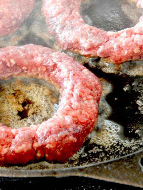 Egg-in-the-Hole Cast Iron Skillet Burgers...a deliciously seasoned hamburger with a cracked egg fried in the middle.  Perfection in a burger! (sweetandsavoryfood.com)