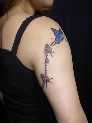 blue butterfly tattoos and small black flower can make your shoulder more 