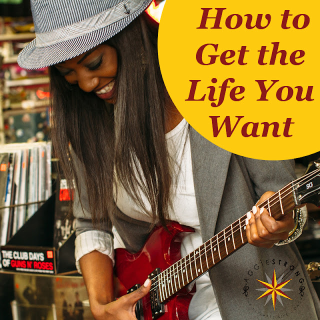 black girl smiling, playing the guitar