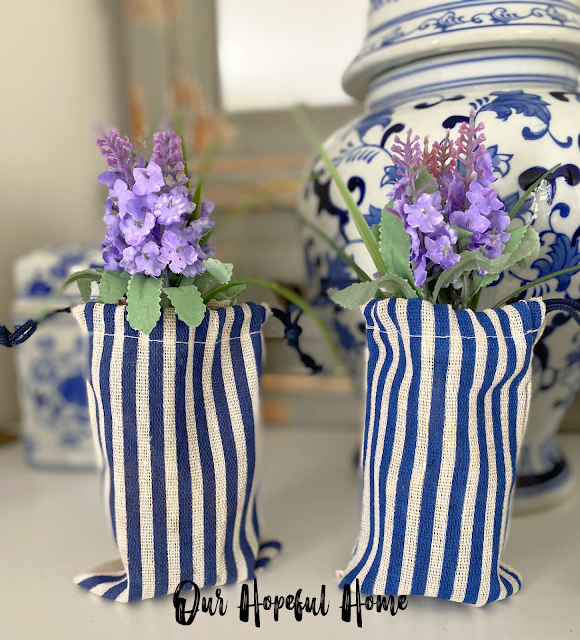 dainty purple flowers in blue and white striped gift bags