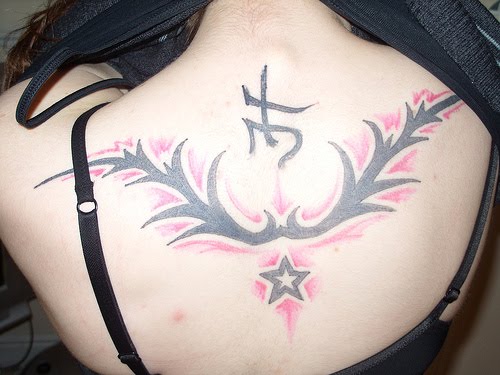 tribal back tattoo women. Tribal and star tattoo picture