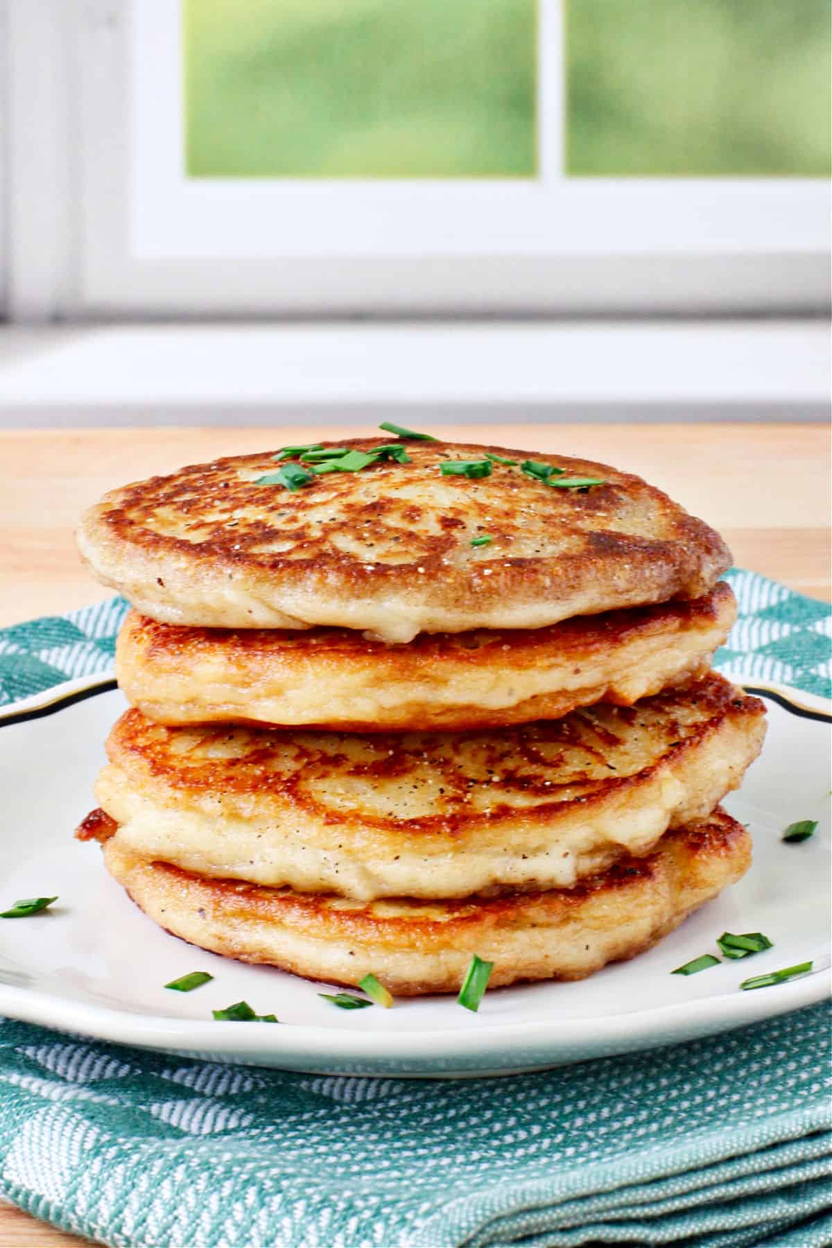 Irish Potato Cakes stacked on a small plate.