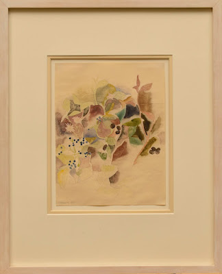 Cream-colored frame and mat around watercolor painting with muted yellow, pink, purple and brown shades. The work depicts abstracted floral forms.