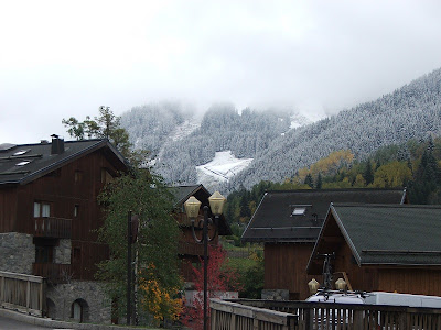 Snow on the ground behind Meribel chalets