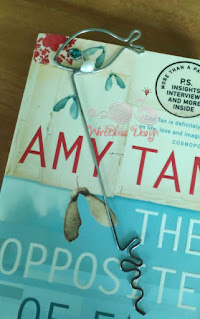 Wire wrapped fish bookmark with Swarovski Crystal and Pearl on top of novel cover