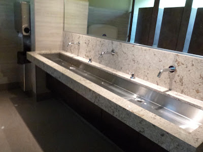 Newly renovated Ladies restroom at Snug Harbour shows stainless steel trough-style sink.