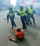 Runner lies on the street as bombs exploded during the Boston Marathon (boston marathon vicitm)