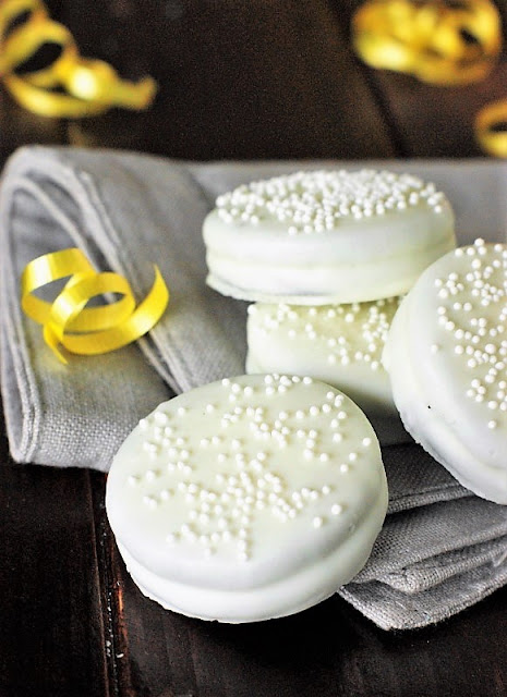 Bridal Shower White Chocolate Oreos Image ~ With a dip in white chocolate & sprinkling of white sprinkles, Oreos are ready to celebrate!  A fun and easy, crowd-pleasing bridal shower or wedding treat.   www.thekitchenismyplayground.com