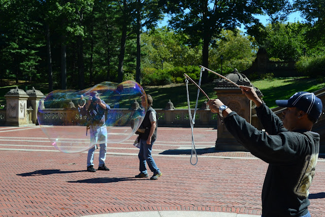man blowing bubbles central park