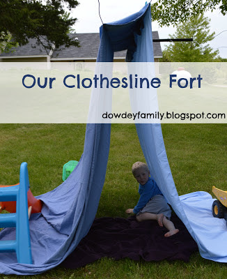 Reading outside in a clothesline fort