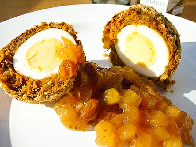 Spicy tiffin eggs cut in half and served with apple chutney.