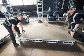 Roadies building a stage 