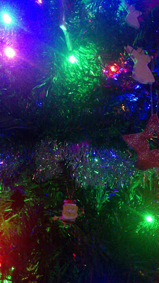 close up of Christmas tree with lights and tinsel