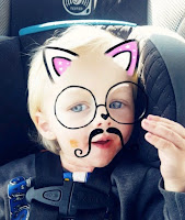 young boy picture with bunny ears, glasses, and mustache drawn on